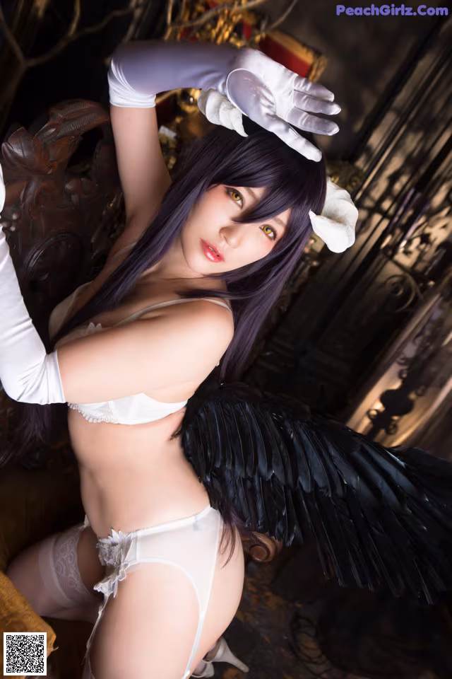 A woman in a white lingerie with black wings.
