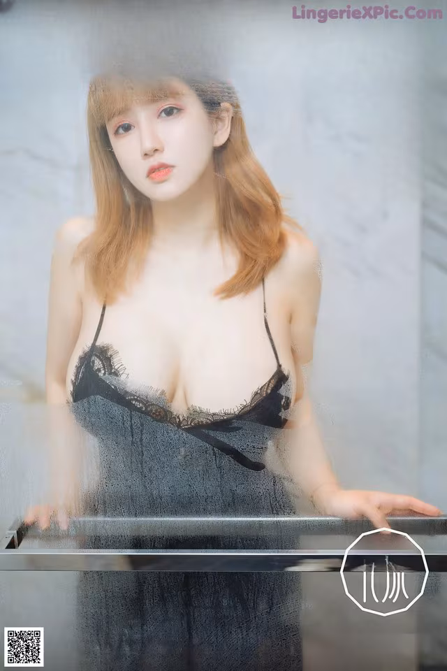 A woman in a black lingerie posing for a magazine cover.