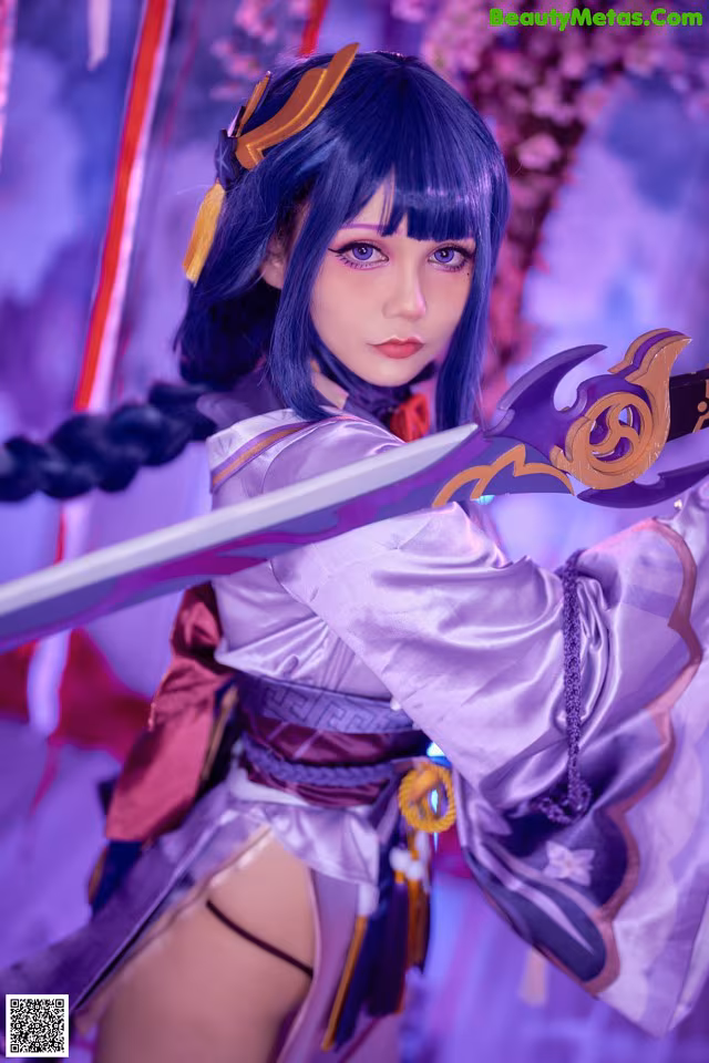 A woman in a purple outfit holding a sword.