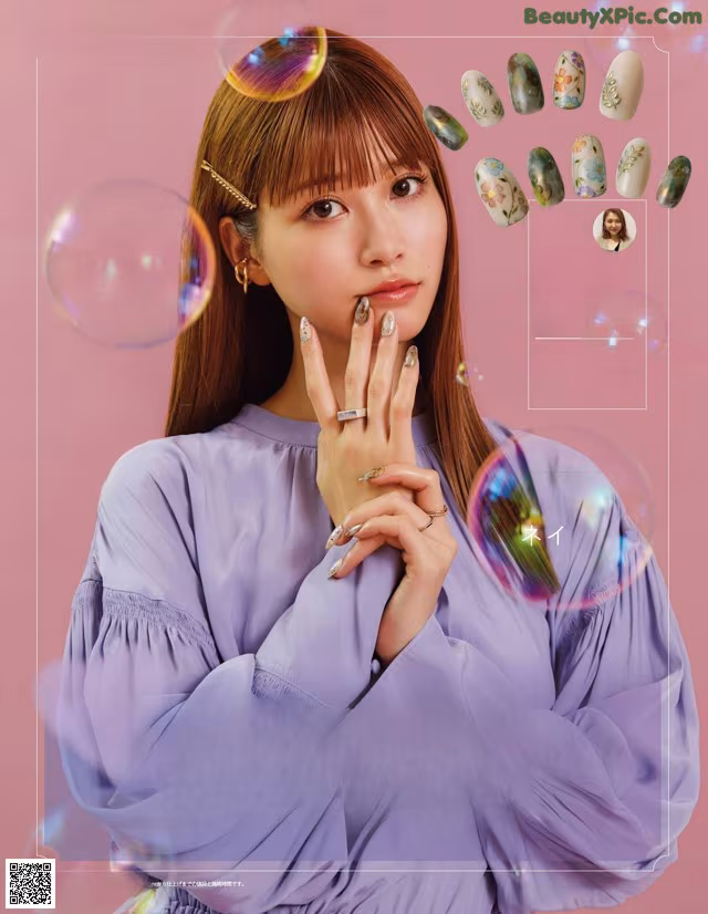 A woman in a purple shirt is posing for a magazine.