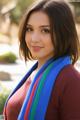 A woman wearing a colorful scarf posing for a picture.